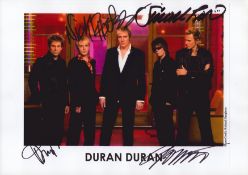 Duran Duran signed 10x8 inch approx. colour promo photo. Signed by Simon Le Bon, Nick Rhodes, John