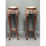 A pair of Chinese marble inset hardwood urn stands, 97cm high