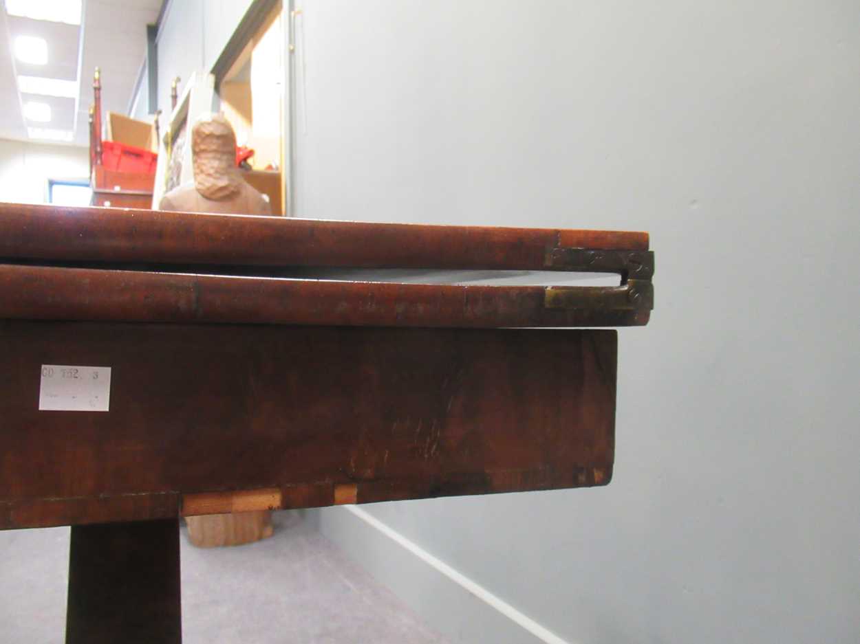 A Regency mahogany fold over tea table, the rounded rectangular top on a tapered column raised on - Image 7 of 9