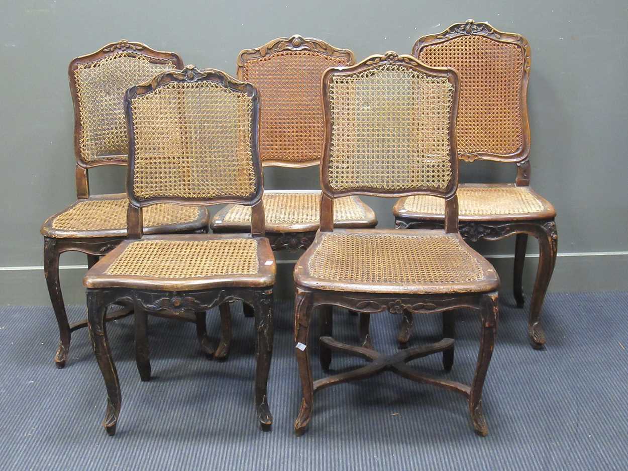 A match set of five French Louis XV style carved frame caned chairs