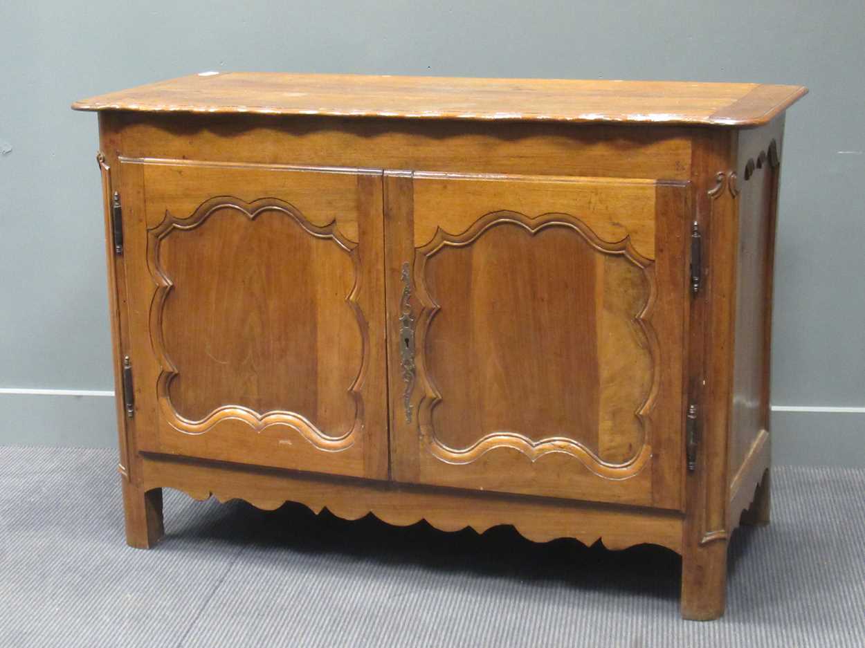A 19th century French walnut side cabinet, the shaped top above two cupboard doors, 95 x 138 x 63cm