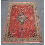A Persian red ground rug with central medallion, 216 x 141cm