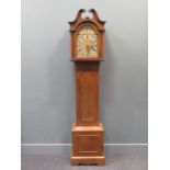 A George III style oak longcase clock with a swan pediment hood, brass arched dial and a chime/