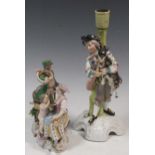 A Stitzendorf figure group of a man with a horn and lady and cherub at his feet; a German
