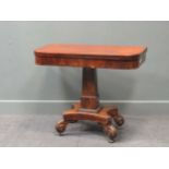 A Regency mahogany fold over tea table, the rounded rectangular top on a tapered column raised on