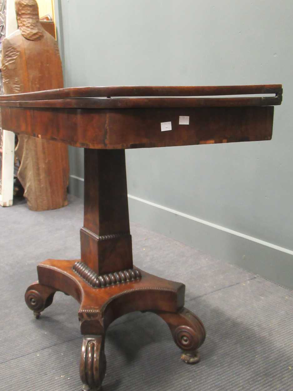 A Regency mahogany fold over tea table, the rounded rectangular top on a tapered column raised on - Image 3 of 9