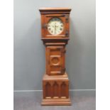 A 19th century Gothic oak longcase clock with an associated arched dial inscribed Henry Steward