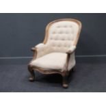 A Victorian button back armchair in cream
