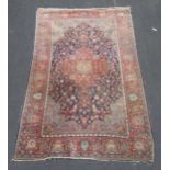 A red ground Persian rug, 205 x 130cmHistoric moth damage and some reduction to the pile in