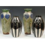 A pair of Doulton stoneware vases, 33cm high; together with a pair of silvered black Secessionist-