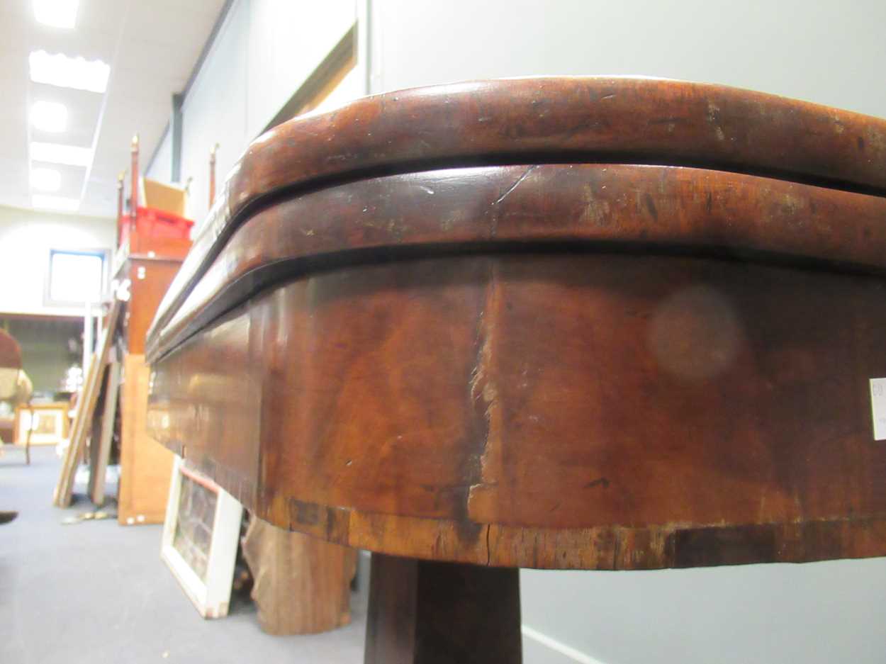 A Regency mahogany fold over tea table, the rounded rectangular top on a tapered column raised on - Image 5 of 9