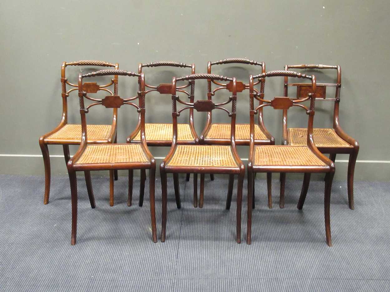A set of four Regency caned dining chairs with ropetwist backs and sabre legs, a pair of chairs of