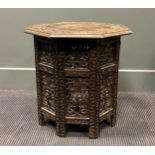 An early 20th century Anglo-Indian folding occasional table, the octagonal carved top above the