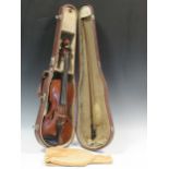 An early 20th century violin with one-piece back and red/brown varnish, old repairs, with bowThe