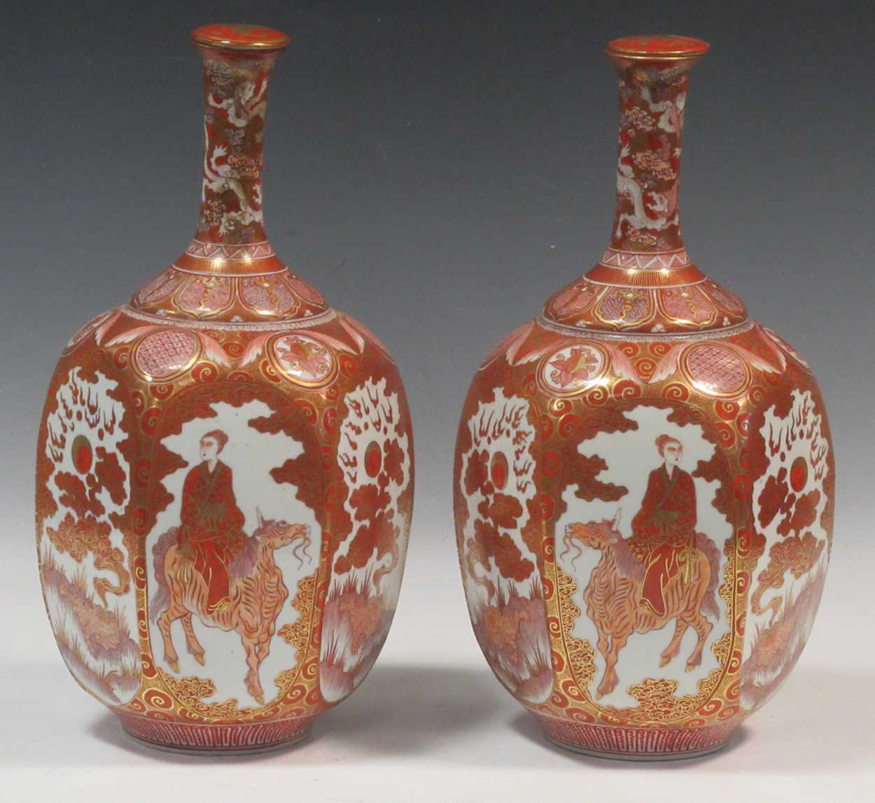 A pair of Japanese Kutani-style vases with bottleneck stems, decorated with mythical creatures