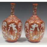 A pair of Japanese Kutani-style vases with bottleneck stems, decorated with mythical creatures