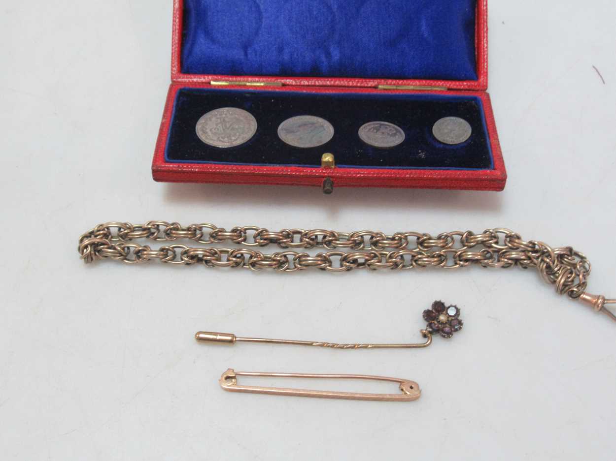 A watch chain tested as 9ct gold, a floral pin tested as '9CT', a brooch stamped '9CT GOLD', gross