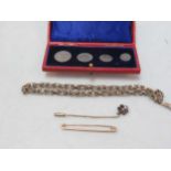 A watch chain tested as 9ct gold, a floral pin tested as '9CT', a brooch stamped '9CT GOLD', gross