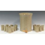 A ceramic water dispenser with a wooden spout 30cm high and matching ceramic cups (qty)