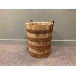 A coopered barrel with raised iron handles, 71 x 60cm