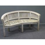 A 20th century teak garden bench with curved back, stamped 'Bramble Crest'85 x 159 x 60cm