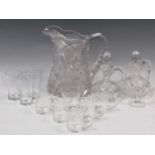 A collection of glassware to include a cut glass single handled jug, two small decanters, various