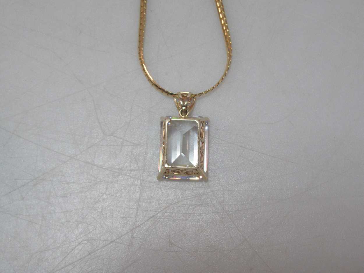 A cubic zirconia pendant hallmarked 14ct gold, suspended from a hallmarked 18ct gold chain, gross - Image 2 of 4