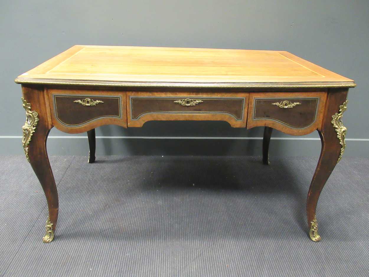 A Louis XV style writing table with three drawers on cabriole legs with gilt brass mount details, 80