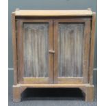 A small limed oak cupboard with gothic linen fold doors, 68 x 60 x 30cm