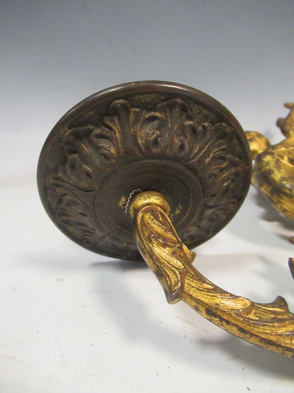 A pair of 19th century gilt metal wall sconces together with a brass candlestick with dolphin - Image 2 of 5