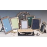 Six silver photograph frames, a caddy spoon, lobed paperweight and various plated items