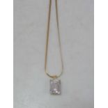 A cubic zirconia pendant hallmarked 14ct gold, suspended from a hallmarked 18ct gold chain, gross