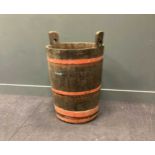 A coopered oak barrel 88cm high and 60cm wide