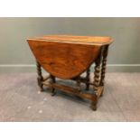 A 17th century style oak gateleg table on barley twist supports, 71 x 90 x 47cm (closed) and 71 x 90