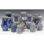 An assortment of traditional Westerwald pottery, to include, jugs, tankards, a vase, etc, tallest