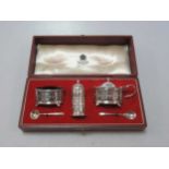 A silver cruet set cased by Asprey, each main piece engraved Asprey London, with blue glass liners