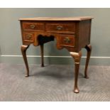 A walnut lowboy fitted with four drawers around the kneehole on cabriole legs, 79 x 80 x 43cm