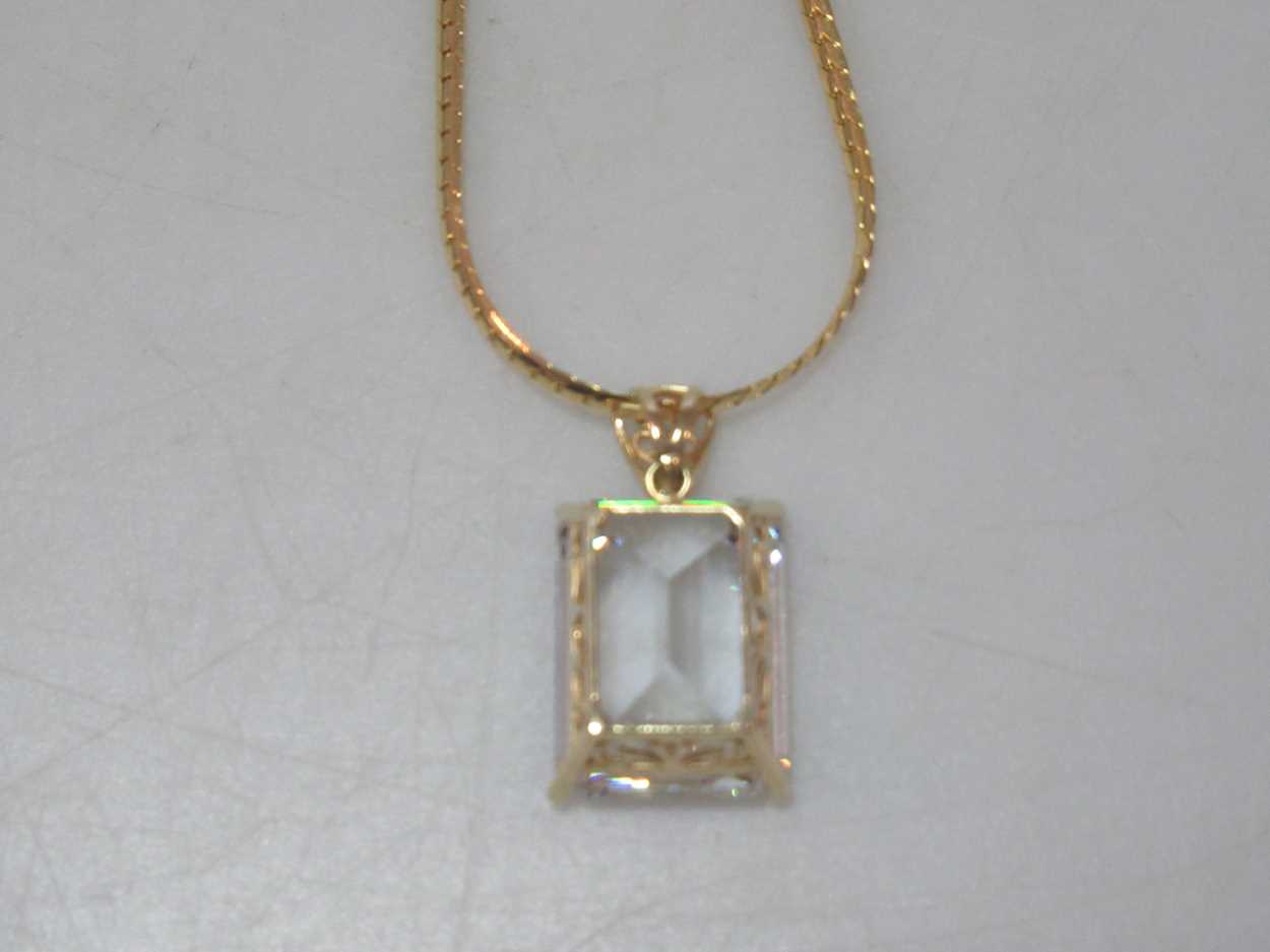 A cubic zirconia pendant hallmarked 14ct gold, suspended from a hallmarked 18ct gold chain, gross - Image 4 of 4