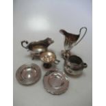 A silver helmet shaped cream jug together with a silver sauce boat, 2 silver pin trays, a silver