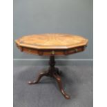 A twelve sided walnut parquetry top tripod table, central star inlaid motif, with two frieze