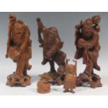 Six carved wood Chinese figures to include a seated Buddha and others, together with five carved