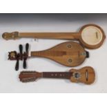 A Chinese lute or Liuqin; armadillo skin Bolivian miniature instrument with 10 strings and a 5