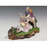 A Continental figure group of a courting couple with a dog, 22cm high