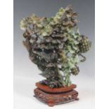 A carved jade ornament, 30cm high including stand