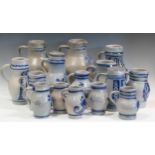 A collection of blue and grey painted and incised Westerwald jugs, tallest 30cm (15)