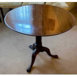 A George III mahogany tilt top supper table with carved tripod legs