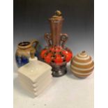 A mid-century earthenware table lamp base, a West German lamp base, a vase, a large black and