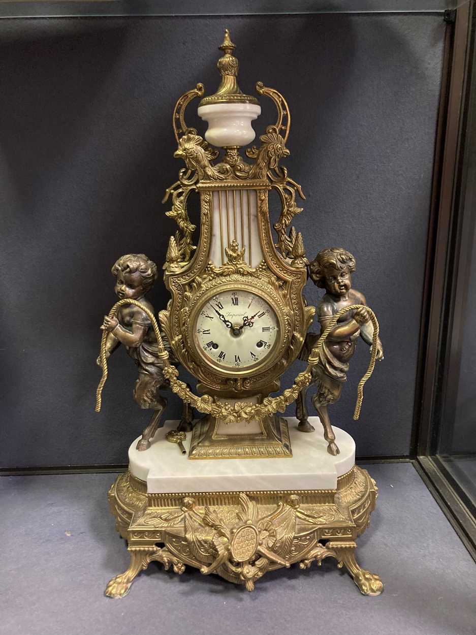 A French style reproduction gilt metal and marble lyre shape mantel clock, 60cm high