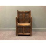 A 19th century Gothic style oak panelled box seat, the back with pair of panels carved with