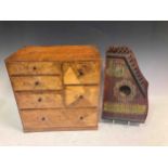 A small parquetry inlaid chest of drawers, 33.5 x 33 x 22cm, and a small zither (2)